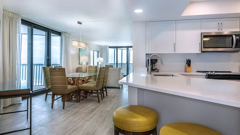 Fully-equipped kitchen and dining area with table & chairs