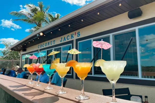 A line-up of frozen drinks on a ledge outside
